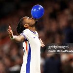 BOURNEMOUTH, ENGLAND - SEPTEMBER 14: Christopher Nkunku of Chelsea celebrates scoring his team's first goalby blowing up a ballon during the Premier League match between AFC Bournemouth and Chelsea FC at Vitality Stadium on September 14, 2024 in Bournemouth, England.